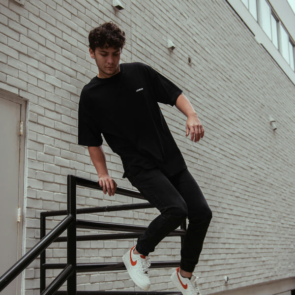 Man jumping off staircase railing and wearing the Arcane Duo.