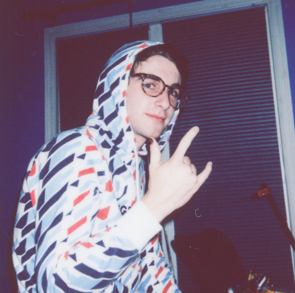 Man in a hoodie doing the devil's horns gesture while wearing Majestic Y nail polish.
