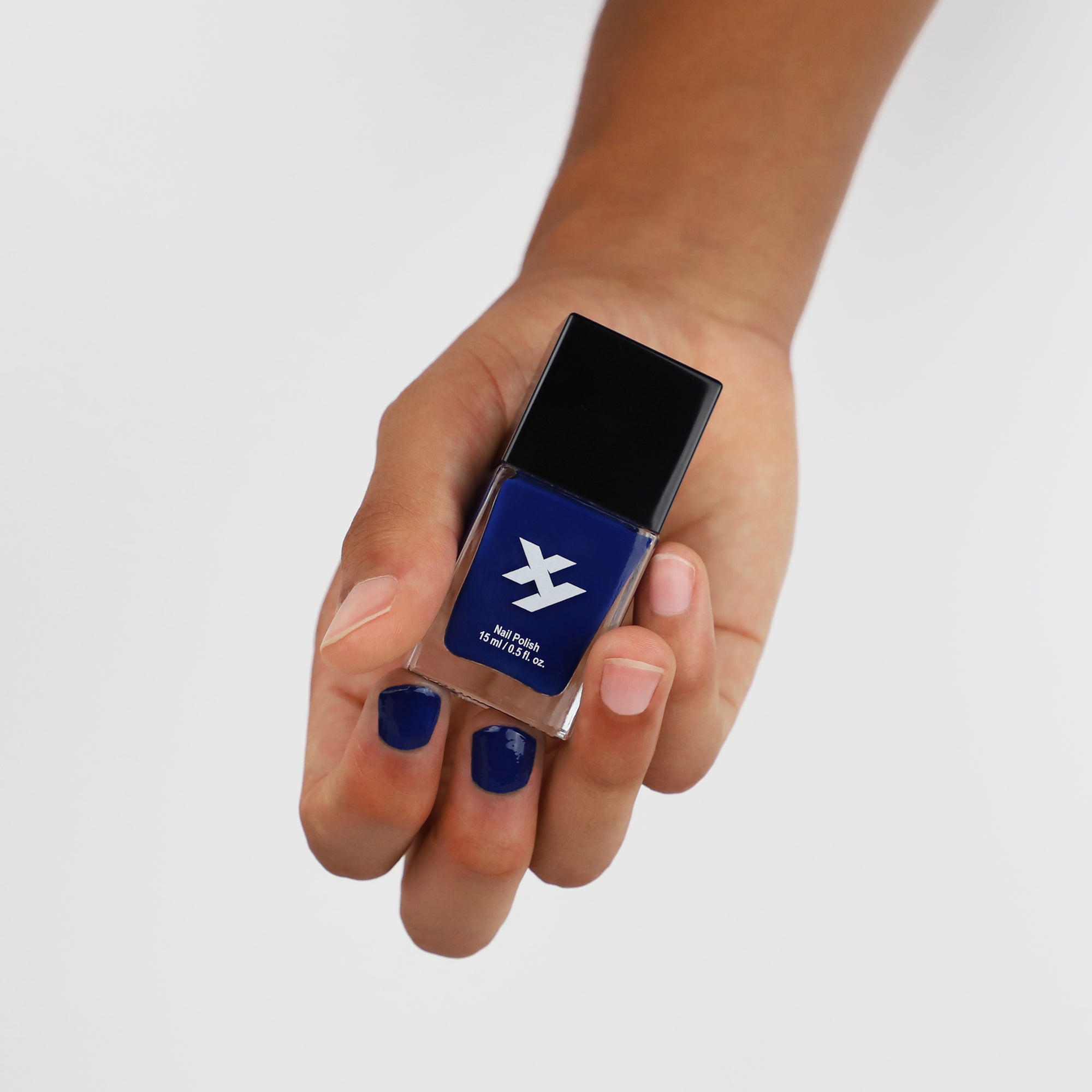Model holding a bottle of Night Owl X nail polish.