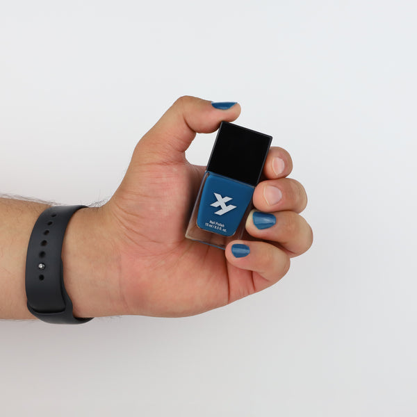 Model holding a bottle of Renegade X nail polish.
