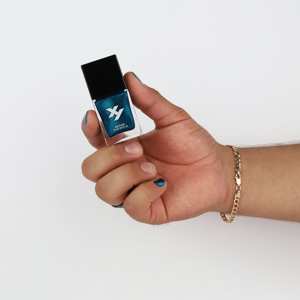 Model holding a bottle of Renegade Y nail polish.