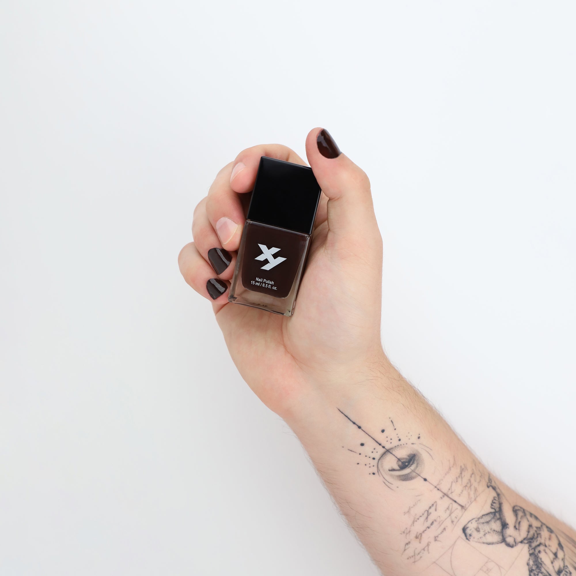 Model holding a bottle of Rooted X nail polish.